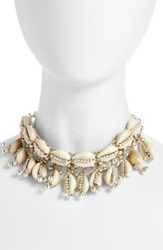 "Find CHILD OF WILD Lakshmi Shell Choker on Editorialist. Dangling beads increase the statement-making potential of this artfully crafted shell choker. 16\" length Hook closure Goldtone and silvertone plate/shell Made in the USA of imported materials" Beach Outfit Accessories, Cowrie Shell Hair Accessories, Ancient Roman Jewelry British Museum, Cowry Shell Jewelry, Cowrie Shell Dress, Shell Necklace Aesthetic, Shell Clothes, Afro Jewelry, Heishi Jewelry