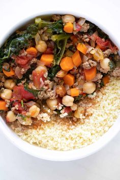 a white bowl filled with rice and vegetables