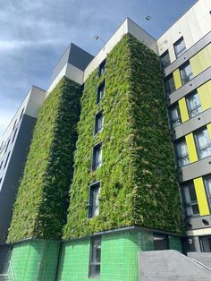 an apartment building covered in green ivy