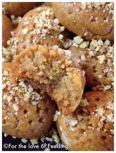 a close up view of some cookies with nuts on top and the words for the love of feeding written below