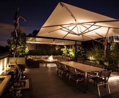 an outdoor dining area is lit up at night