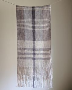 a gray and white checkered blanket hanging from a clothes line