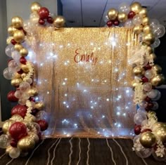 a photo frame decorated with balloons and streamers in red, white and gold colors