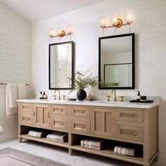 a bathroom with two sinks and mirrors in it's center, next to a toilet