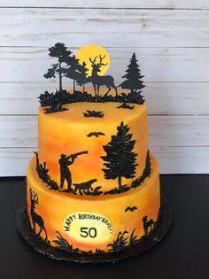 a birthday cake is decorated with an image of a man hunting at night and the number 50 on it