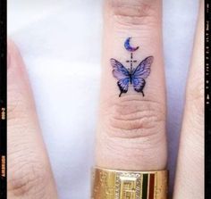 two fingers with tattoos on them, one has a butterfly and the other has a crescent moon