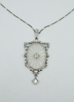 A stunning original Art Deco Pendant Necklace set with gorgeous Old European Cut Diamonds with an etched carved crystal oval center set in 14 Karat White Gold with a 14 Karat gold link chain. A delicate romantic necklace dating to the Art Deco period, circa 1900 - 1940. We love these Art Deco etched crystal jewels adorned with antique diamonds. They are lovely worn everyday, with an elegant evening gown, or adorning your wedding attire. Art Deco Old European Cut Diamond Crystal Pendant Necklace 14 Karat White Gold Description A stunning original Art Deco Pendant Necklace set with gorgeous Old European Cut Diamonds with an etched carved crystal oval center set in 14 Karat White Gold with a 14 Karat gold link chain. A delicate romantic necklace dating to the Art Deco period, circa 1900 - 194 Art Deco Pendant Necklace, Romantic Necklace, Gold Link Chain, Art Deco Pendant, Crystal Pendant Necklace, European Cut Diamonds, Antique Diamond, Crystal Necklace Pendant, Diamond Crystal