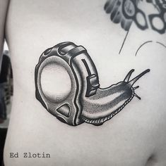 a black and white photo of a snail tattoo