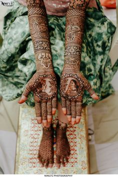 the hands and feet of a woman with henna tattoos on their palms are shown