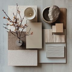 an arrangement of different materials on a table with a vase, bowl and other items