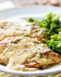 chicken with gravy and broccoli on a plate