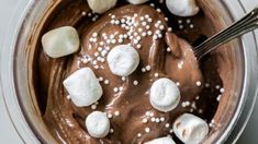 a bowl filled with chocolate pudding and marshmallows