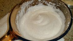 a bowl filled with white liquid sitting on top of a counter