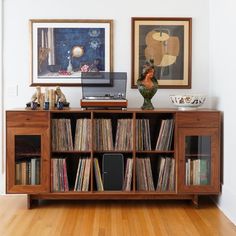 a record player is on top of an entertainment center