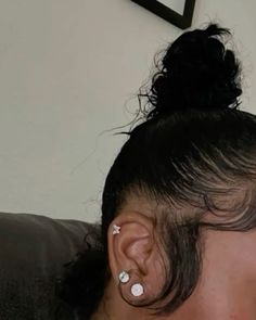 a woman with ear piercings sitting on a couch