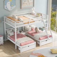 two white bunk beds sitting next to each other on top of a hard wood floor