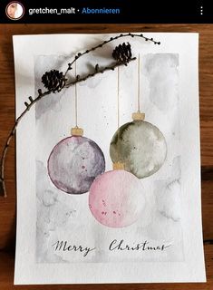 a card with three ornaments hanging from it