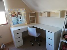 a white desk with drawers and a mirror on top of it next to a window