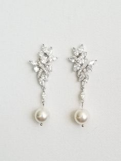 "Gorgeous sparkly cubic zirconia wedding earrings for the bride. Handcrafted with Swarovski pearls and high quality cubic zirconias. For pierced ears only. I do have other types of pearls available such as freshwater pearls and shell pearls that are in different shapes & sizes. Please contact for other options. ♥ SIZE: 2 1/8\" long x 3/4\" wide ♥ COLORS: Silver, Gold, Rose Gold ♥ PRODUCTION TIME: Ready to ship out in 1-2 business days ♥ IMPORTANT: Please be sure to read my policy section for Silver Pearl Diamond Earrings For Wedding, Wedding Crystal Earrings With Pearl Drop, Pearl White Bridal Earrings With Pearl Drop, Wedding Pearl Drop Crystal Earrings In Cubic Zirconia, Pearl Embellished Cubic Zirconia Wedding Earrings, Pearl White Cubic Zirconia Earrings For Wedding, Bridal Drop Earrings With Pearl Drop And Cubic Zirconia, Wedding Pearl Earrings With Sparkling Cubic Zirconia, Cubic Zirconia Bridal Drop Earrings With Pearl