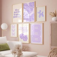 a living room with pink walls and pictures on the wall, including a white couch