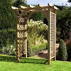 a wooden arbor in the middle of a garden