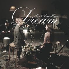 a man and woman sitting on chairs in front of a microphone with the words dream written over them