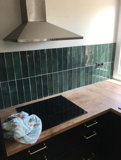 a stove top oven sitting inside of a kitchen next to a counter with a towel on it