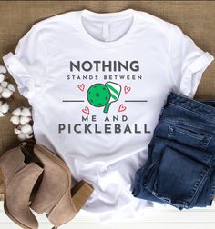 a white t - shirt with the words nothing stands between me and pickleball