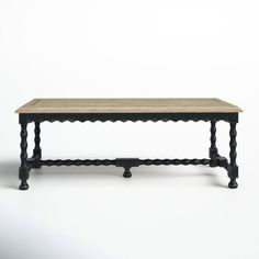 an old wooden table with black legs on a white background