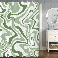 a green and white shower curtain in a bathroom