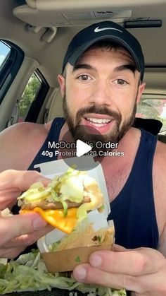 a man eating a sandwich in the back seat of a car