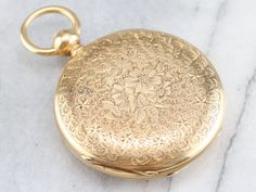 This is the most exquisite pocket watch we've had the opportunity to offer, in perfect condition, this is quite the collector's piece! This antique pocket watch dates to the 1860s, by the J.W. Tucker San Francisco watch company. The face bears two dials, one for seconds and the other for minutes and hours; black, simple hands and stark Roman Numerals. This is a hunter's case, beautifully ornate, one side has blooming flowers in its center while the other has a shield design with a scrolling "LLI 18k Gold Watch, Antique Pocket Watch, Gold Pocket Watch, Pocket Watch Antique, Shield Design, Watch Companies, Pocket Watches, Metal Pendant, Blooming Flowers