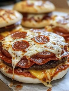 pepperoni and cheese pizzas are sitting on top of a cardboard box, ready to be eaten