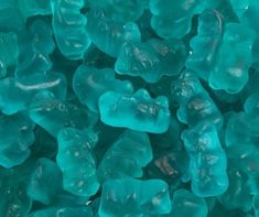 blue gummy bears are piled together on top of each other