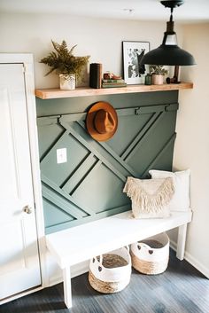 a white bench sitting under a wooden shelf next to two baskets on top of it