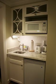 the small kitchen is clean and ready for us to use in its new owner's house