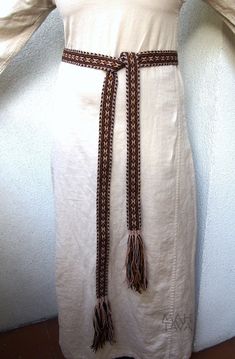 "I'd like to present a tablet woven belt made from wool. It is a perfect addition to medieval and early medieval costume, Viking and Slavic. Length: about 200 cm + a few cm of tassels Width: 3,7 cm (1,45\") Material: wool 100% Color: very dark brown, light(golden)brown, beige You are buying the actual tablet woven belt in the photo. Please note that due to different color adjustment of your and my screens the colors of the band may appear slightly different than they really are. We've been makin Tablet Woven Belt, Handmade Brown Belts For Festival, Handmade Artisan Brown Belt, Traditional Brown Belt For Festivals, Costume Viking, Viking Belt, Medieval Belt, Viking Reenactment, Card Weaving