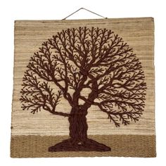 a woven wall hanging with a tree on it