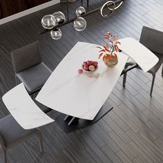 a white table with four chairs and a vase on the top is shown from above