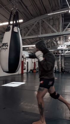 a man is practicing boxing in a gym