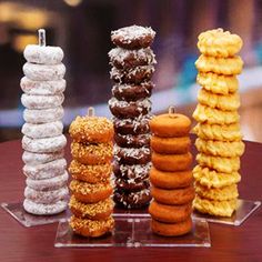 five donuts stacked on top of each other in different shapes and sizes, along with two rows of doughnuts