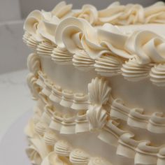 a close up view of a white frosted cake