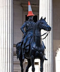 a statue of a man riding on the back of a horse