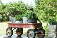 an old wagon filled with potted plants