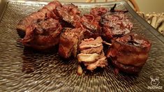 some meat is sitting on top of a glass plate and ready to be cooked in the oven