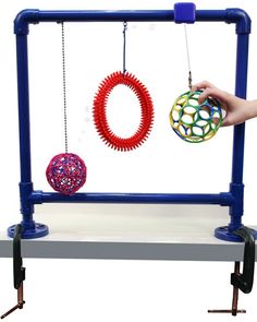 a person is holding an object in front of a machine that has two balls on it