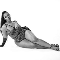 a black and white photo of a woman laying on the floor with her legs crossed