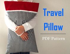 a woman wearing a black and white checkered apron with the words travel pillow on it