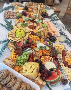 a long table filled with lots of different types of snacks and desserts on top of it