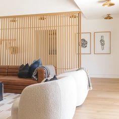 a living room filled with furniture and wooden slats